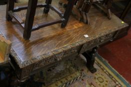 A Victorian carved side table with two frieze drawers on spirally turned supports, scroll legs,