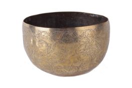 A Persian hammered brass bowl, decorated with figures and animals, 18cm diameter. There is no