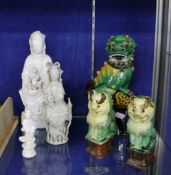 Three Blanc de Chine models of Guanyin; a pair of polychrome painted pottery dogs of Fo; and one
