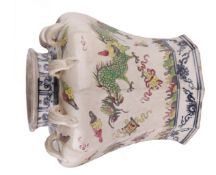 A Chinese pottery vase of baluster shape, with applied lug handles (one missing), decorated with a