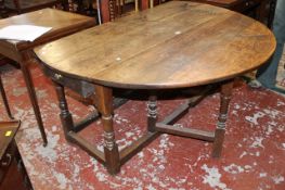 A 17th Century style oak gateleg table with a frieze drawer on ring turned legs 71cm high, 147cm