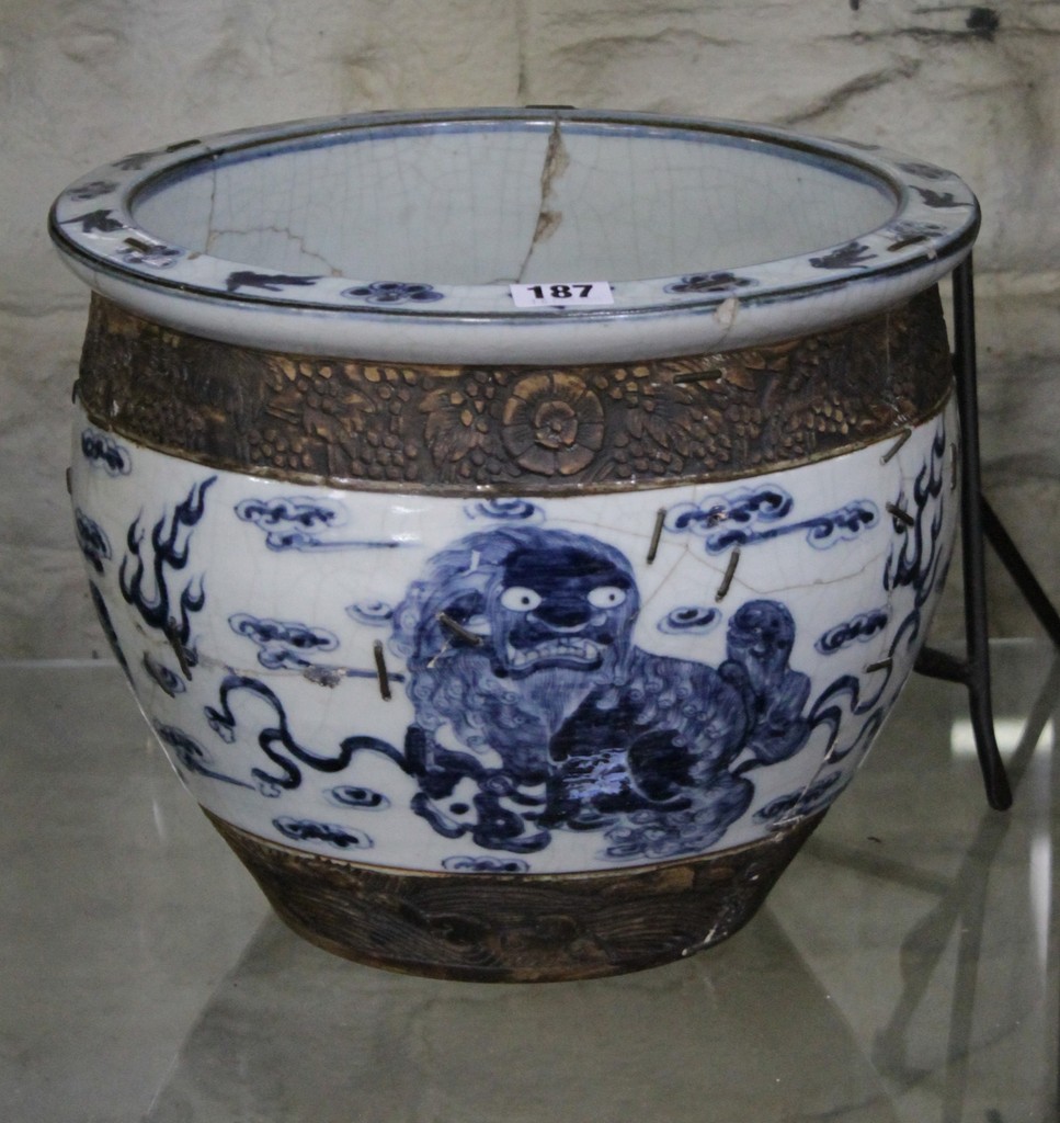 A Chinese blue and white jardiniere, decorated with mythical beasts amid scrolling clouds and