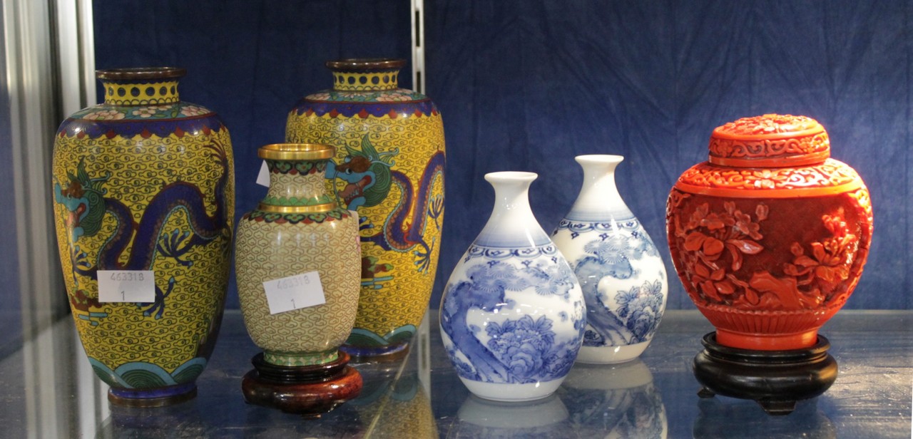 A Chinese cinnabar jar with cover, two cloissonne vases, a single cloissone vase, and two blue and
