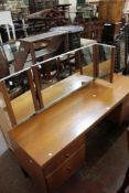 A Heals dressing table, circa 1960 with a triple plate mirror and four drawers 153cm wide There is