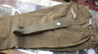 A Royal Engineers Officer`s khaki uniform, a pair of leather putees, a Sam Brown, leather