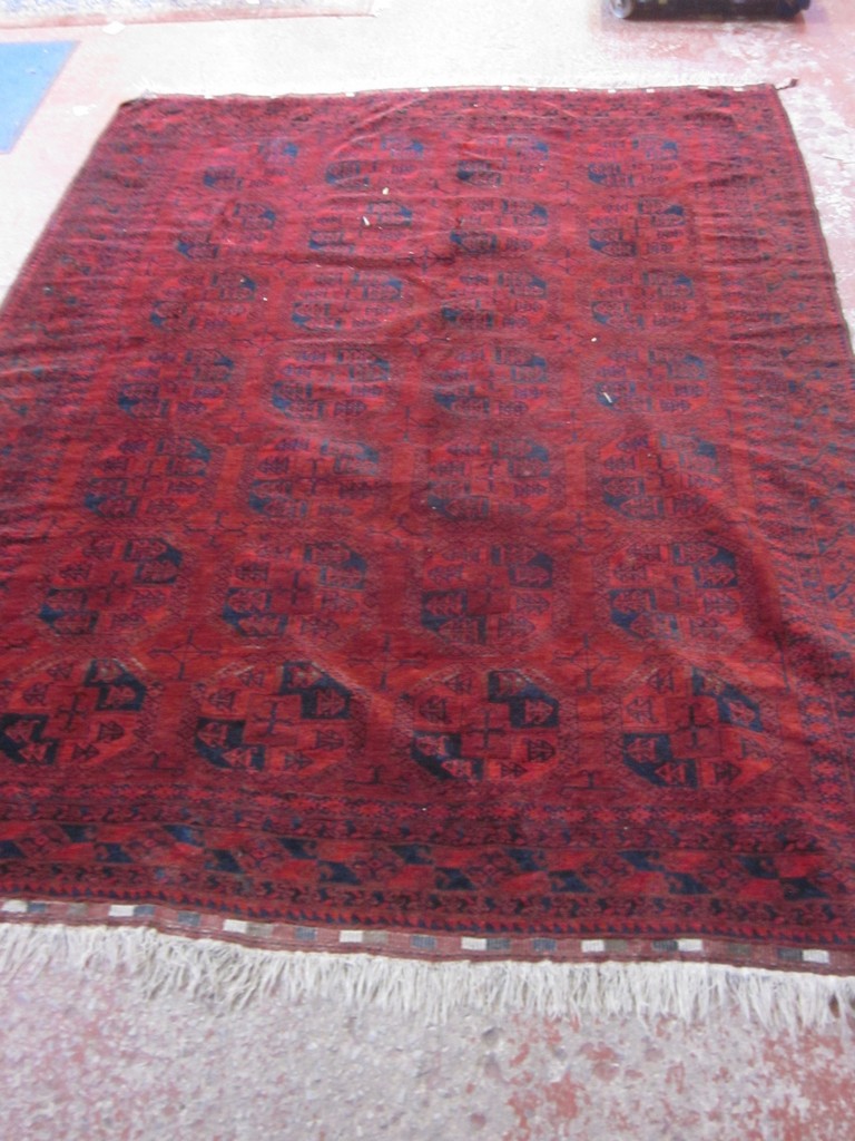 A red ground Afghan carpet, 300 x 230cm