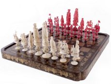 A Chinese export carved and stained ivory figural chess set, late 19th or early 20th century, in red