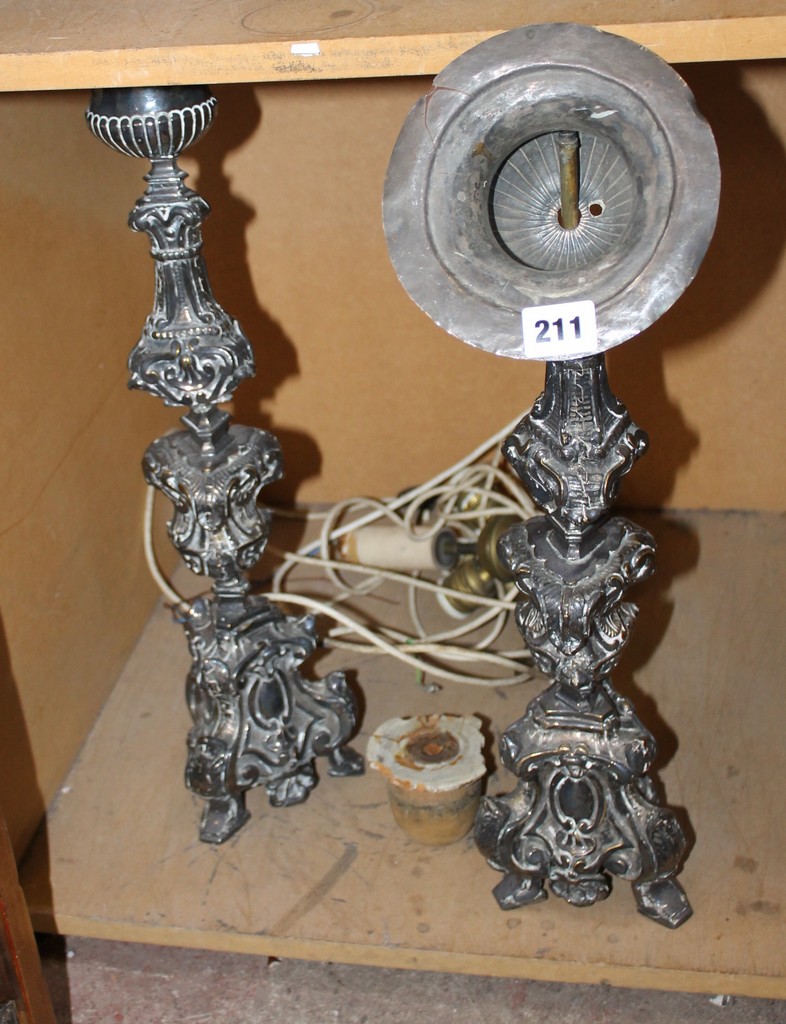A pair of electro-plated altar candlesticks, with urn shaped capitals, the shaped stems with