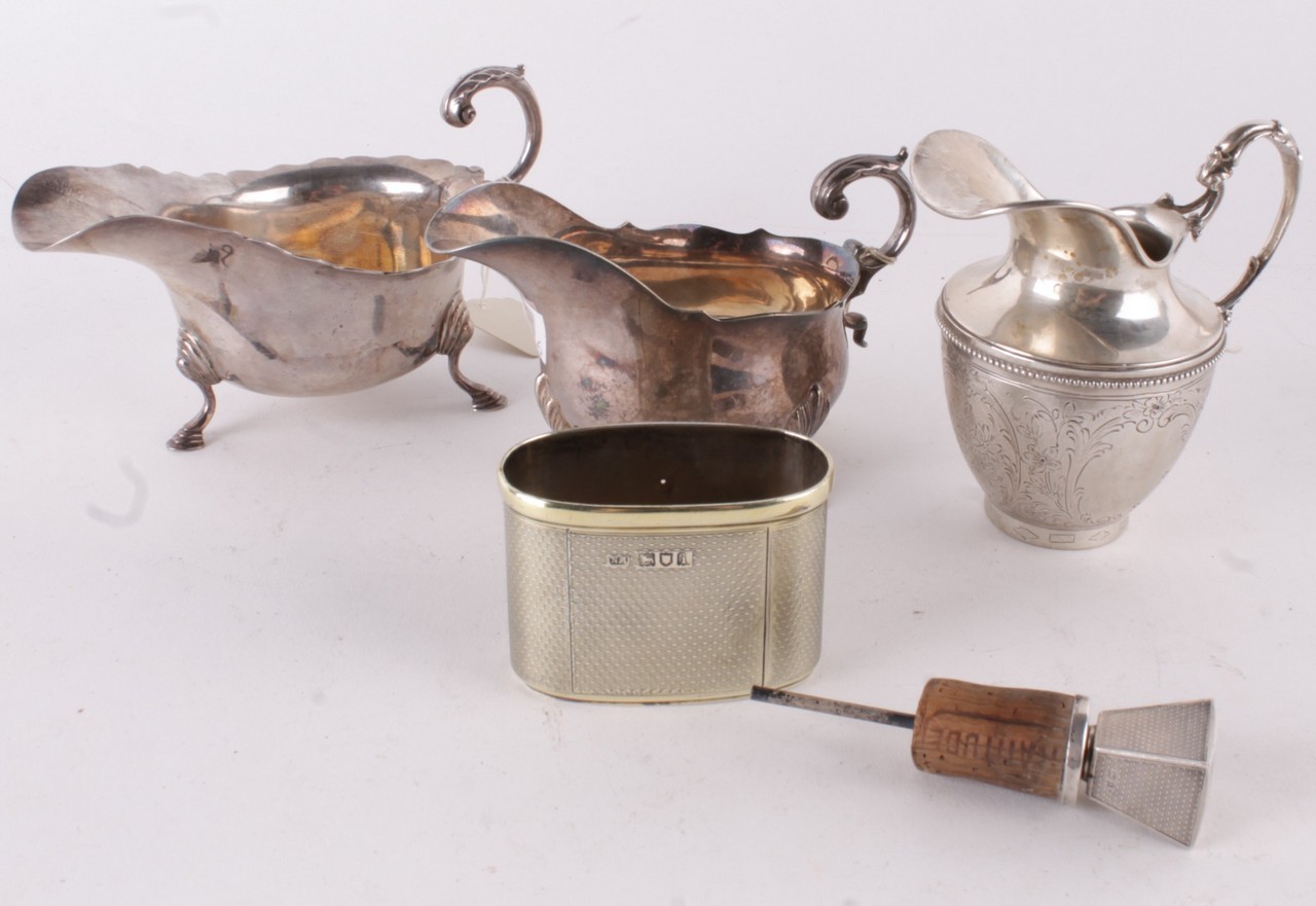 A silver shaped oval sauce boat, maker`s mark obscured, London 1934, with a leaf capped flying