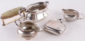 A collection of silver items, to include: a late Edwardian oval cream jug by Deykin & Harrison,