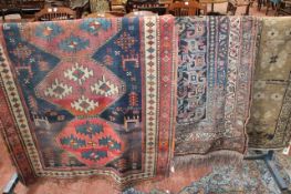 A Caucasian rug 220 x 114cm together with two further rugs (a/f). There is no condition report