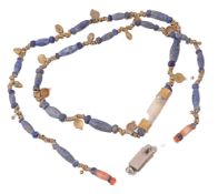 A lapis lazuli bead necklace, the beads of lapis lazuli interspaced with...  A lapis lazuli bead