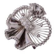 A diamond brooch, the spiralled and folding brooch set with a central...  A diamond brooch,   the
