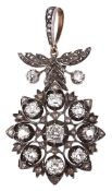 A diamond cluster pendant, the central old cut diamond within a pierced...  A diamond cluster