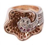 A diamond and ruby ring, with a central scroll set with rose cut diamonds...  A diamond and ruby