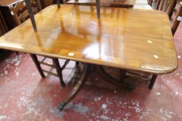 A Regency breakfast table mahogany with rosewood banding on a single pedestal swept base. There is