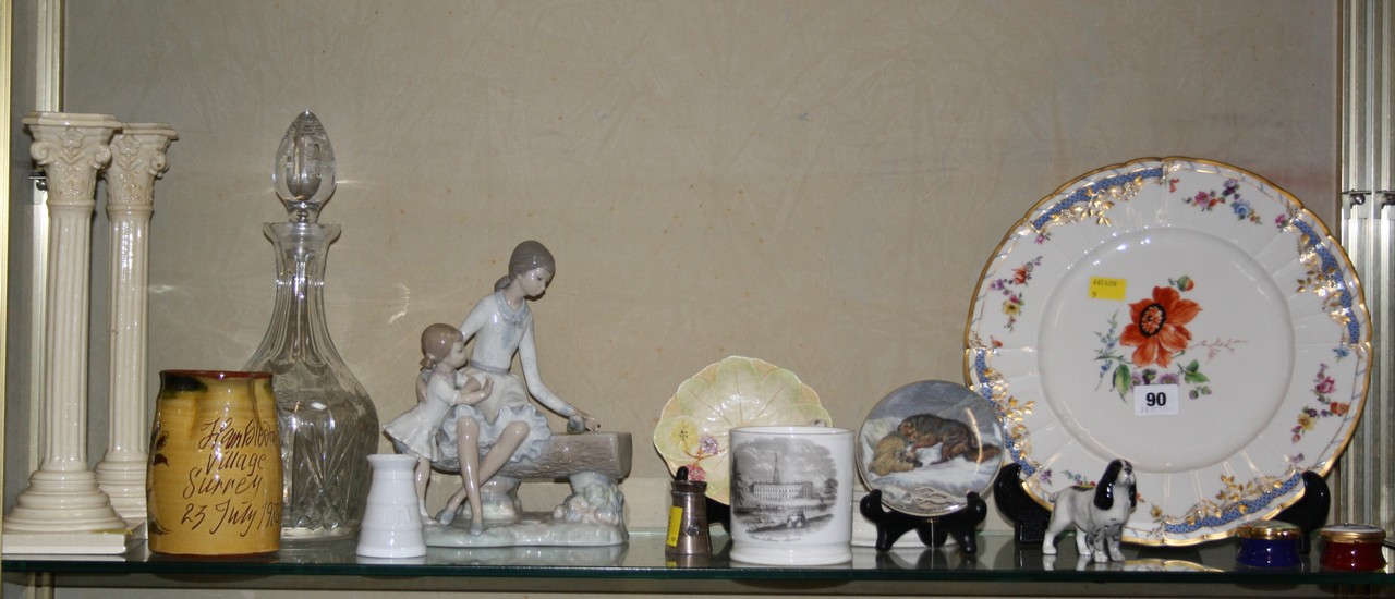 A Nao figure of a mother and child, a KPM cabinet plate, a pair of column candle sticks, Prattware