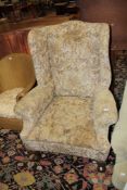 A George III style wing armchair with carved legs and ball and claw feet There is no condition
