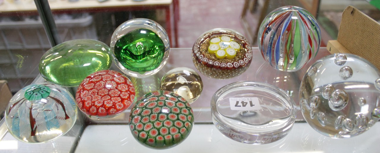 A collection of ten glass paperweights. There is no condition report available on this lot.
