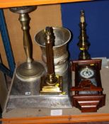 Two brass table lamps, wall clock, plated cake stand, ice bucket. There is no condition report