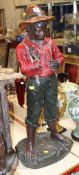 A resin figure of a young bare footed boy wearing a red shirt, 95cm high There is no condition