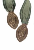 A pair of gilt metal medals from St. Leonards School, attached to a ribbon There is no condition
