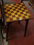 An Edwardian square chess board topped table