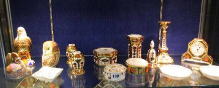 A selection of Royal Crown Derby, including paperweights, boxes, a clock-case and other items,