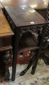 A Chinese hardwood table with carved frieze and an undertier 80cm high, 41cm wide A condition report