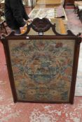 A 19th Century woolwork panel in a carved mahogany frame 116cm high, 86cm wide together with a