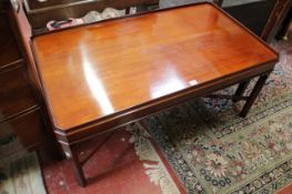 A mahogany coffee table by Arthur Brett, bearing plaque There is no condition report available on
