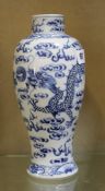 A Chinese blue and white baluster vase with dragon decoration 27cm high. There is no condition