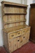 A 19th century pine dresser the platerack above two drawers and cupboards 204cm high, 135cm wide
