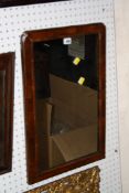 A walnut framed moulded mirror 63cm high, 43cm wide There is no condition report available on this