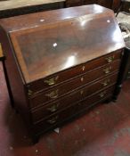 A George III mahogany and crossbanded bureau with a burr maple fitted interior and four long