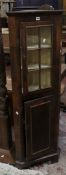 A walnut standing corner cupboard with an upper glazed door 153cm high, 51cm wide There is no