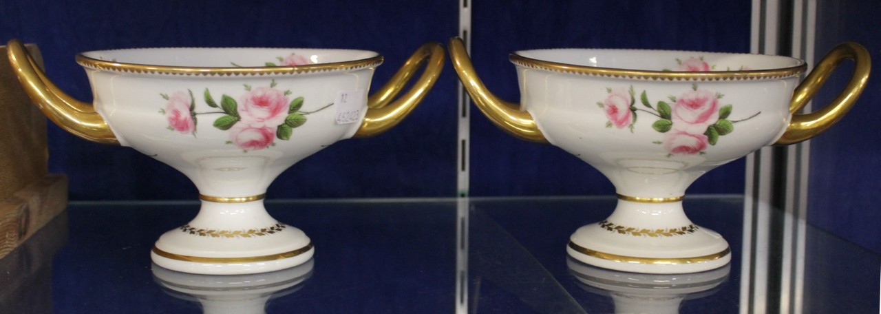 A pair of Coalport porcelain two-handled pedestal bowls painted with pink roses in the Billingsley