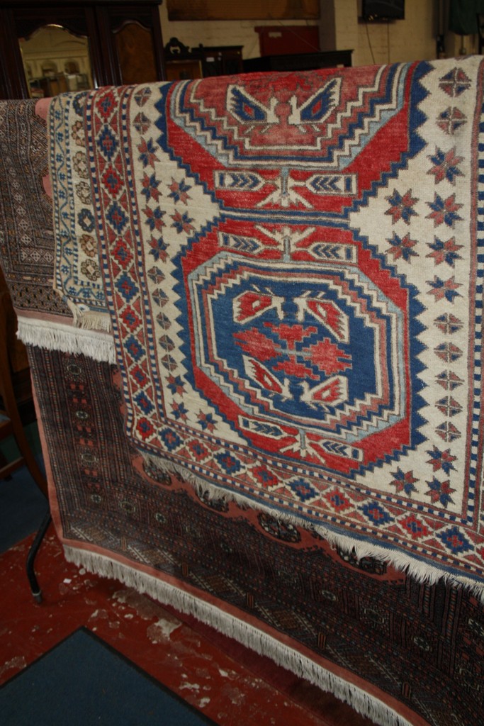 Two Turkish rugs, together with two Bokhara rugs (4) There is no condition report available on