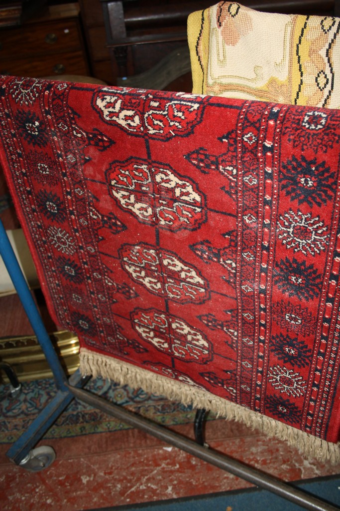 A Caucasian runner with thirteen central guls, red ground approx. 69 x 245cm There is no condition