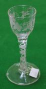 An engraved opaque-twist wine glass, the ogee bowl decorated with a band of fruiting vine and