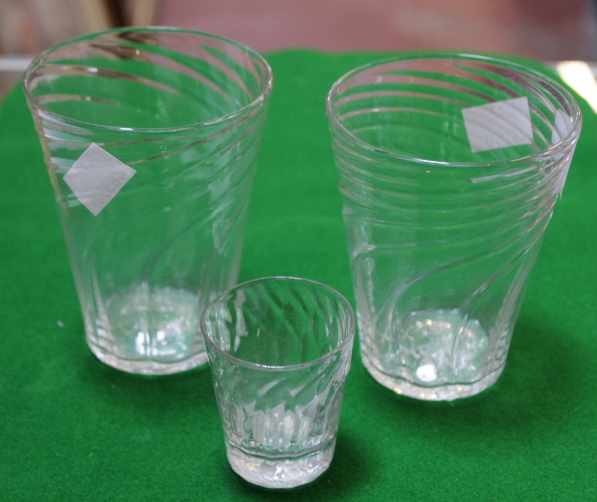 A pair of spirally fluted tumblers and a similar honeycomb moulded dram glass