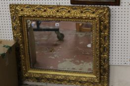 A carved giltwood & composition wall mirror 78cm high, 89cm wide There is no condition report
