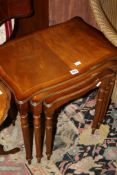 A nest of three mahogany reproduction tables, two small reproduction tables and a Lloyd loom chair