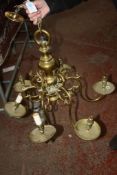 A gilt brass six light chandelier of Dutch design, with vari-baluster stem supporting the scroll