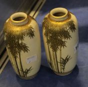 A pair of Japanese Satsuma-type pottery slender ovoid vases, painted and gilt with shooting