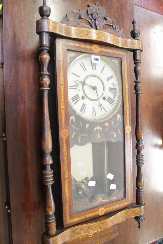 An American inlaid rosewood wall clock, late 19th century, the gong striking movement with two piece