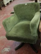An ebonised and upholstered revolving desk armchair There is no condition report available on this