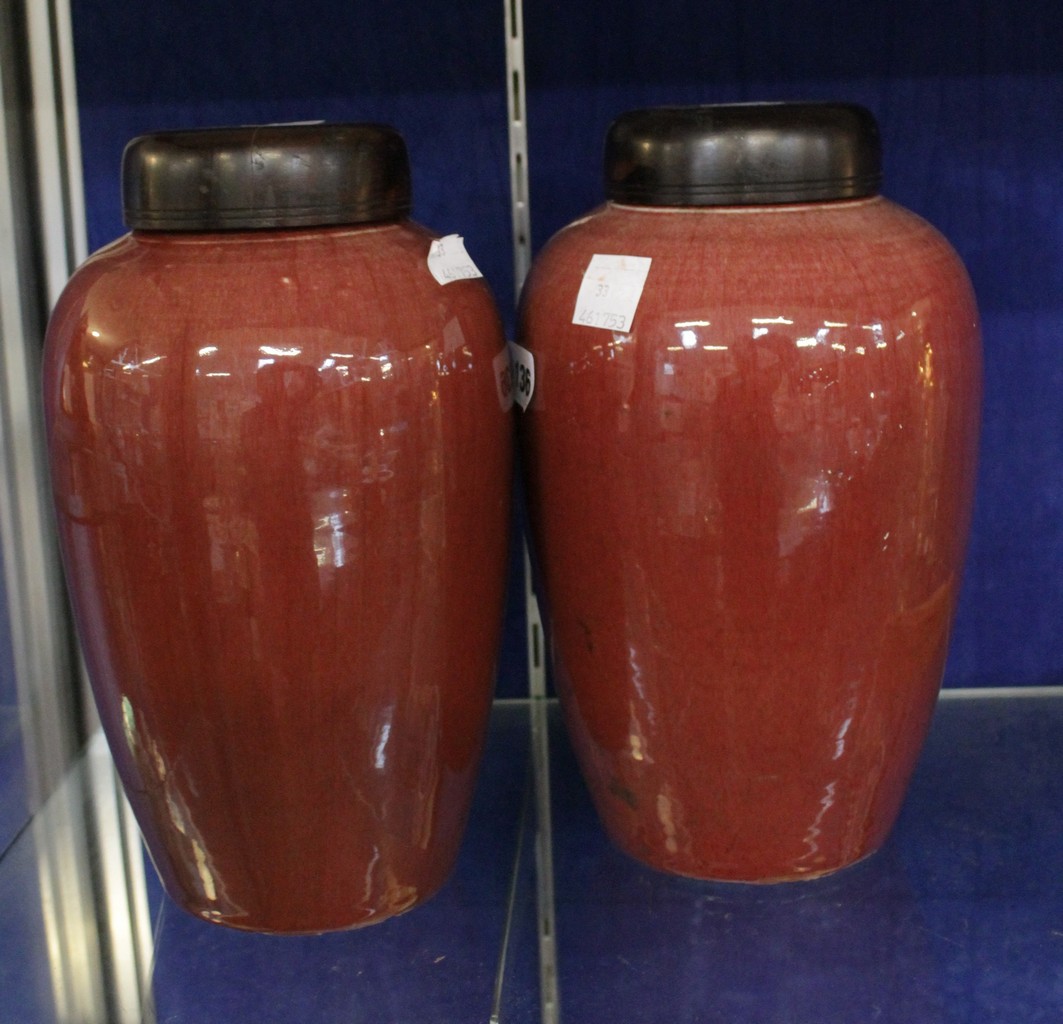 * Two Chinese sang de boeuf vases and covers.27cm high.