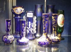 A pair of blue glass vases in the Art Nouveau style and other blue glass vases with overlaid