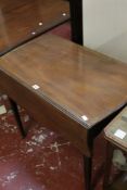 A mahogany Pembroke table with a shaped top with a drawer on square tapering legs There is no
